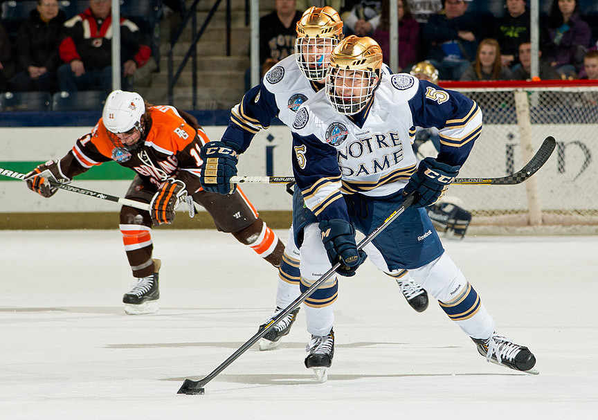 Junior defenseman Robbie Russo leads a rush for the open puck.