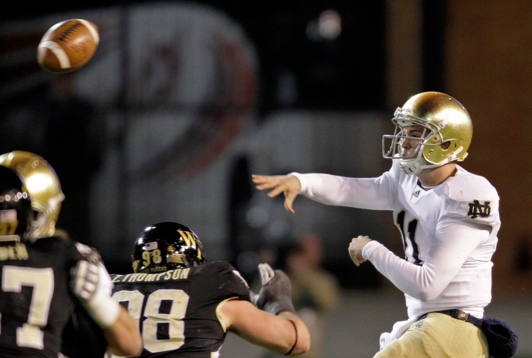 Tommy Rees throws a pass under pressure.