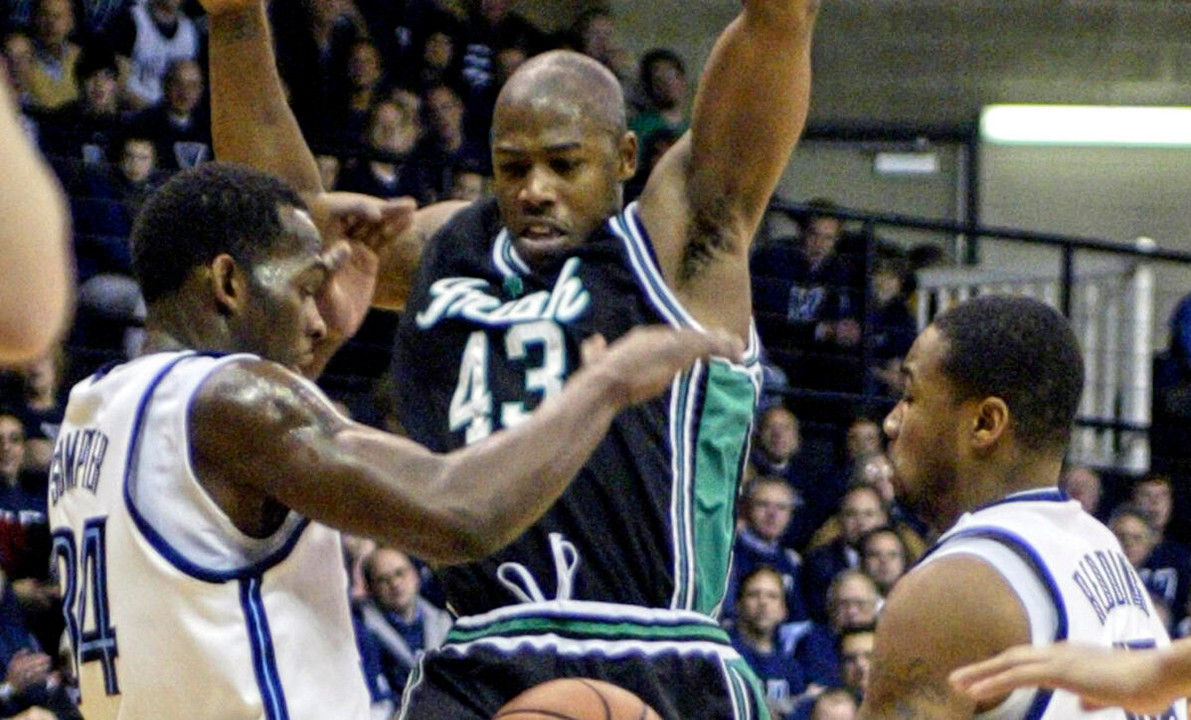 Russell Carter has the ball taken by Villanova's Curtis Sumpter, left, and Reggie Redding in the first half.
