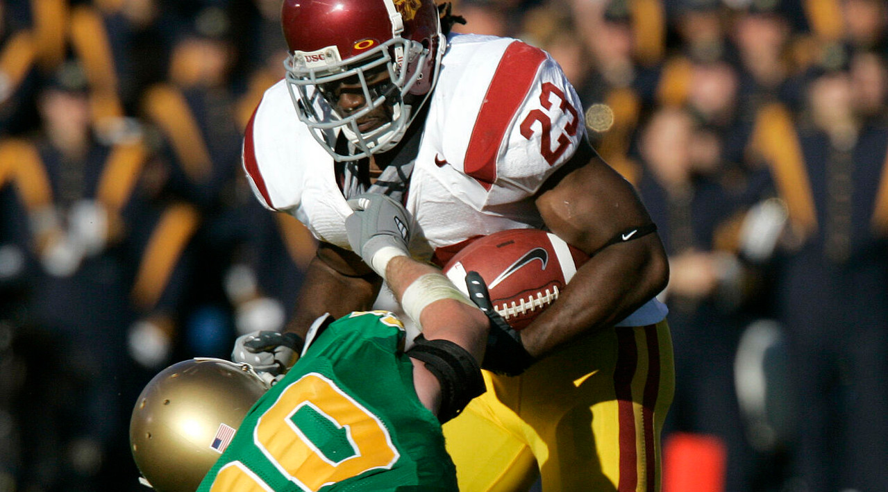 USC running back Chauncey Washington is dragged down by John Ryan. (AP Photo/Michael Conroy)