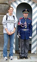 Carolyn Cooper (shown here with one of the Prague Castle guards) tells of jumping over sand mounds and an overheated bus in her diary.