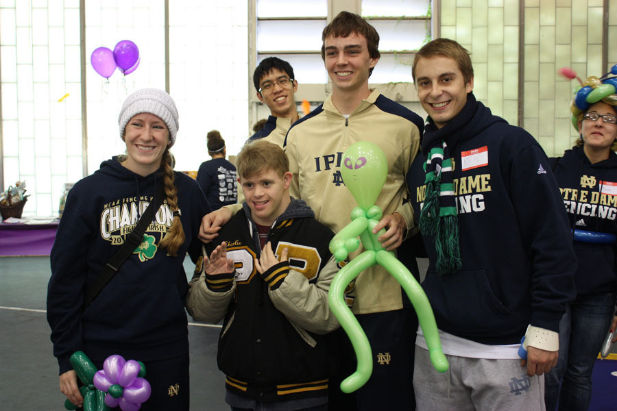 Irish fencers Darsie Malynn, Albert He and Kevin Hassett spend time with a youngster during the 2011 Notre Dame Athletics Buddy Walk on Oct. 1.