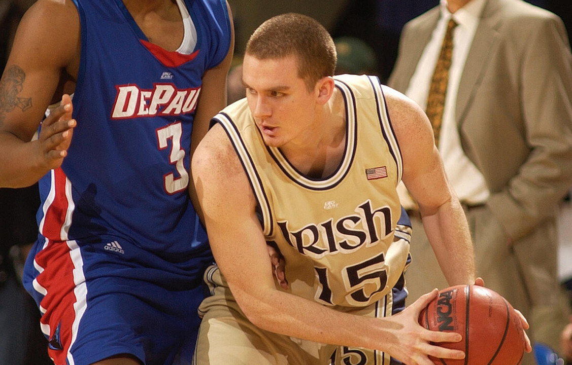 Notre Dame guard Colin Falls (15) gets ready to throw a pass as DePaul guard Draelon Burns (3) defends during the first half of a college basketball game Saturday, March 4, 2006, in South Bend, Ind. (AP Photo/Joe Raymond)