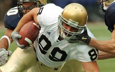 Anthony Fasano dives for extra yardage during the first quarter Saturday