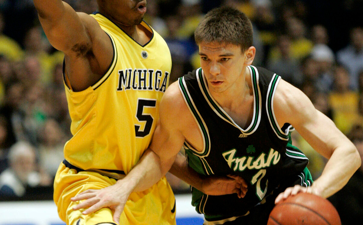 Michigan guard Dion Harris (5) defends against Notre Dame guard Chris Quinn (2) during the first half of a second-round NIT basketball game Monday, March 20, 2006, in Ann Arbor, Mich. (AP Photo/Tony Ding)