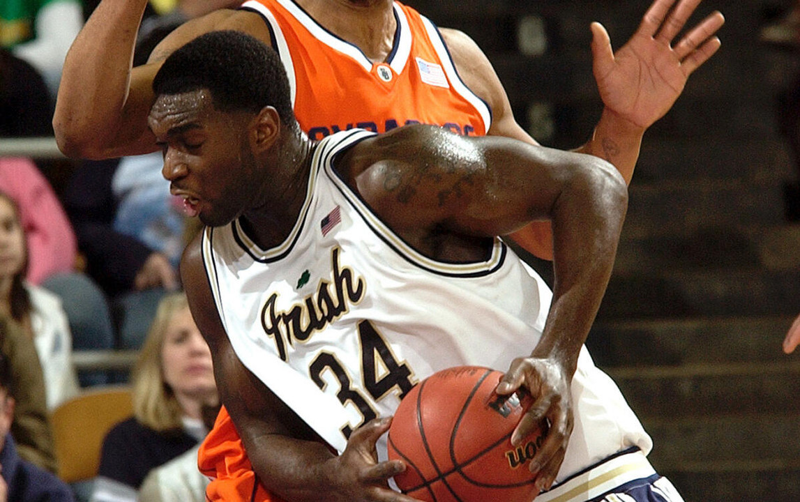 Notre Dame forward Torin Francis drives the lane as Syracuse center Darryl Watkins defends during the first half. (AP Photo/Joe Raymond)