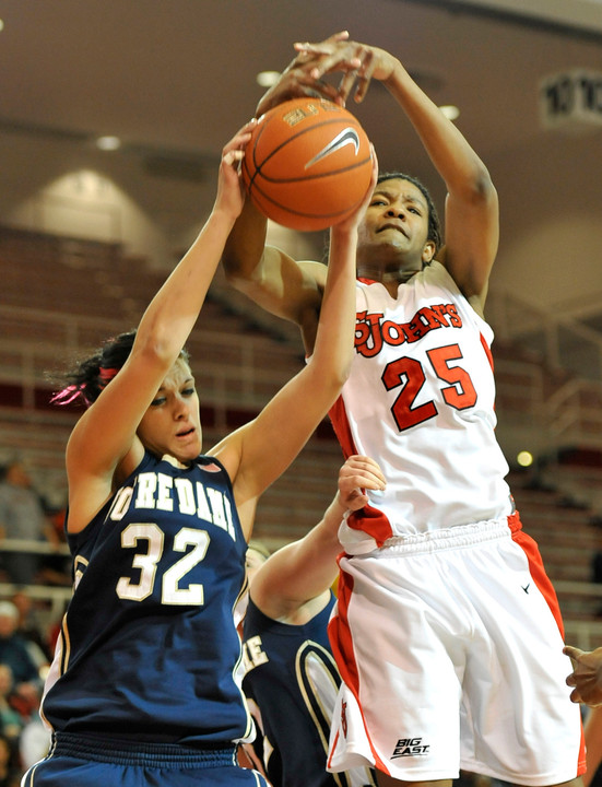 St. John's Joy McCorvey and Notre Dame's Becca Bruszewski battle for a rebound during the first half.