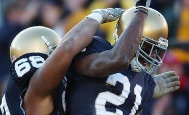 Maurice Stovall reacts with Ryan Harris after a 25-yard touchdown reception during the second quarter.