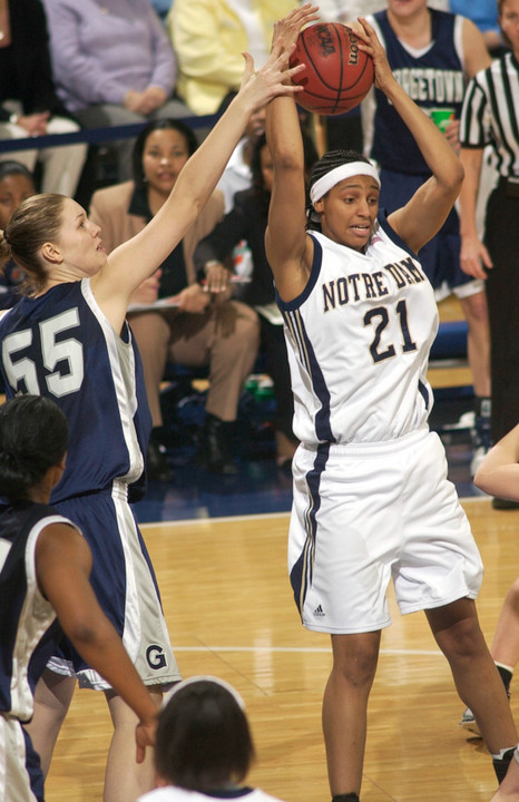 Jacqueline Batteast grabs a pass around Georgetown center Christine Whitt.
