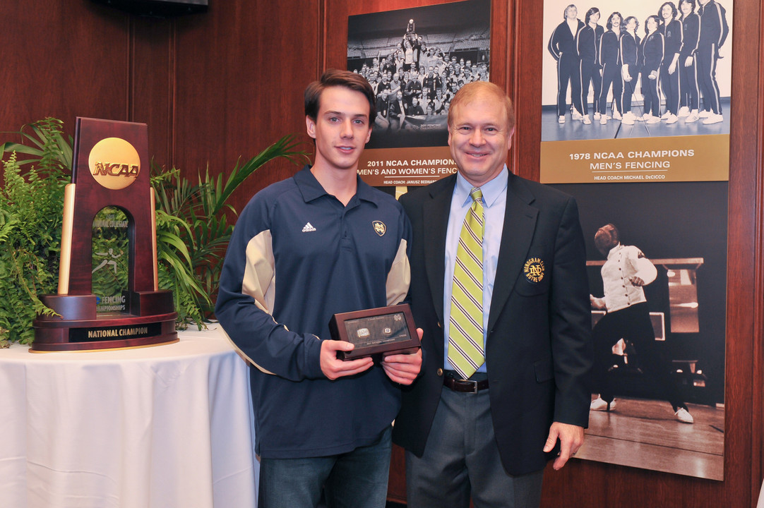 Monogram Club president Dick Nussbaum ('74, '77, baseball) senior Nicholas Crebs ('12) with his national championship ring (photo by Mike Bennett).