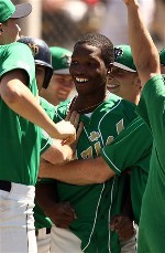 Alex Nettey is greeted by his teammates after hitting the game-ending home run to beat St. John's, 7-5 (all photos by Matt Cashore).