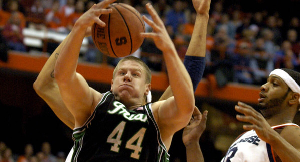 Luke Harangody pulls down a rebound in front of Syracuse's Darryl Watkins, right, during the first half.
