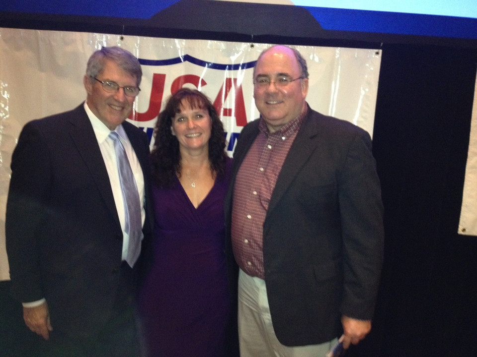 Former Notre Dame swimmer Beth Winkowski with women's interim head coach Tim Welsh (left) and former assistant coach Randy Julian (right).