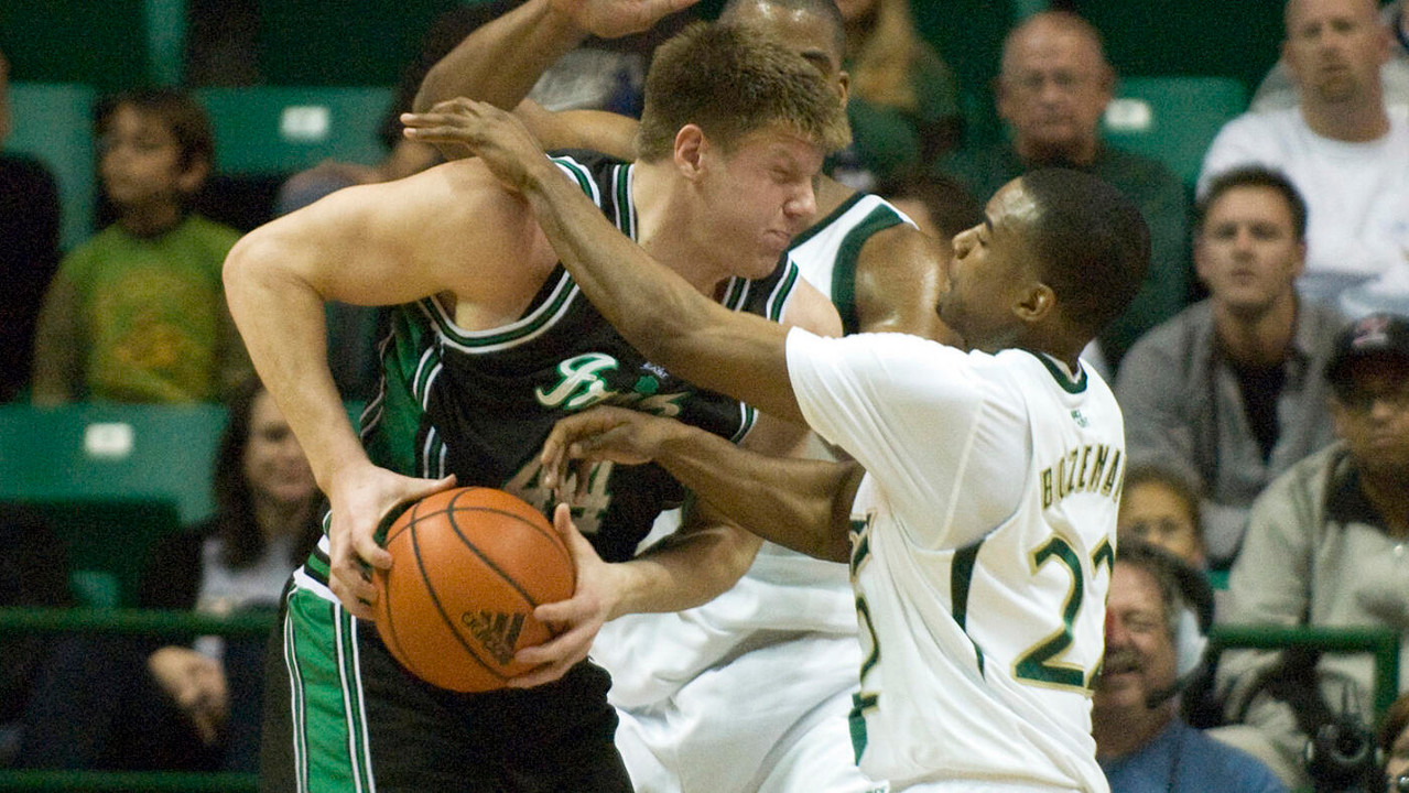 Luke Harangody collides with USF's Solomon Bozeman under the basket. (AP Photo/Steve Nesius)