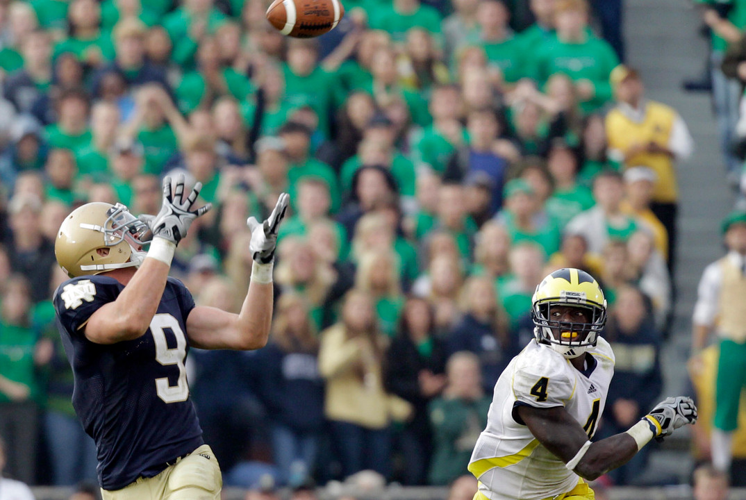 Tight end Kyle Rudolph, left, catches a pass over Michigan safety Cameron Gordon for a 95-yard touchdown late in the fourth quarter. (AP Photo/Michael Conroy)