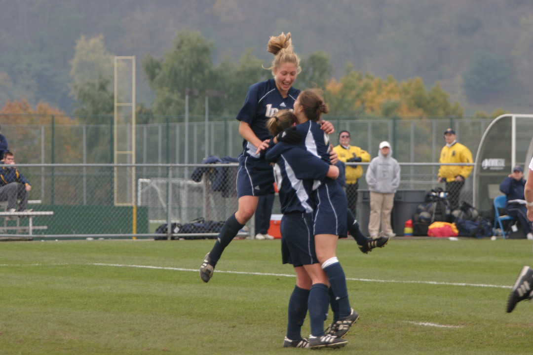 Amanda Cinalli (jumping), Brittany Bock (left) and Kerri Hanks (right) each are among the final-15 candidates for the MAC Hermann Trophy.
