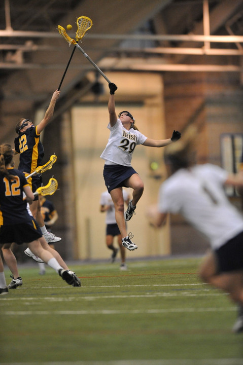 Freshman midfielder Shaylyn Blaney goes high to win a draw versus Canisius.  She got her collegiate career off to a fast start with four goals and two assists in the 22-10 win over Canisius.