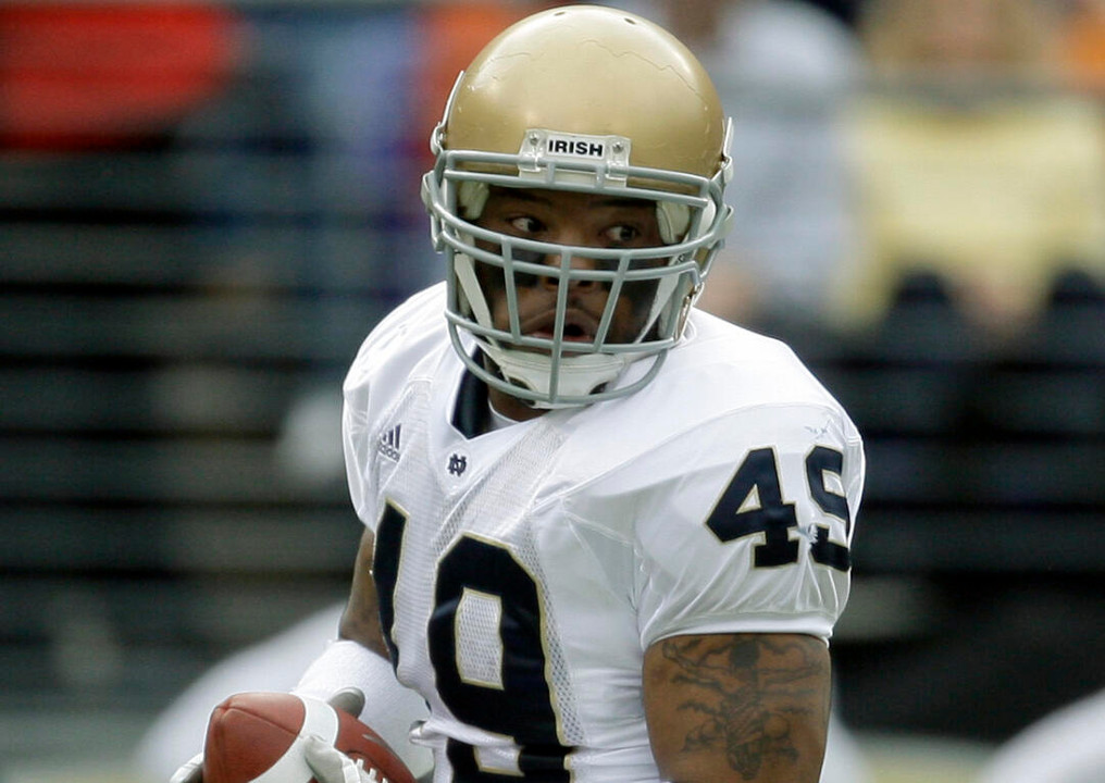 Toryan Smith returns a blocked punt for a touchdown against Navy during the first half. (AP Photo/Rob Carr)