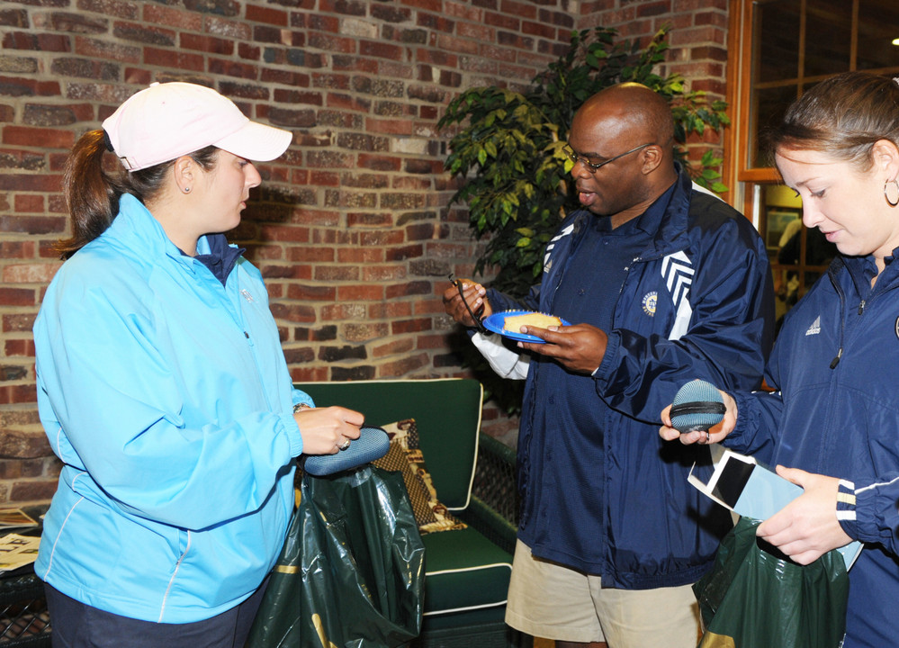 Reggie Brooks (center) with Kyle Veltri (left) and Erika Whitman (right) checkout the sunglasses donated by Monogram Club Board Member Jennifer Slosar-Smith.