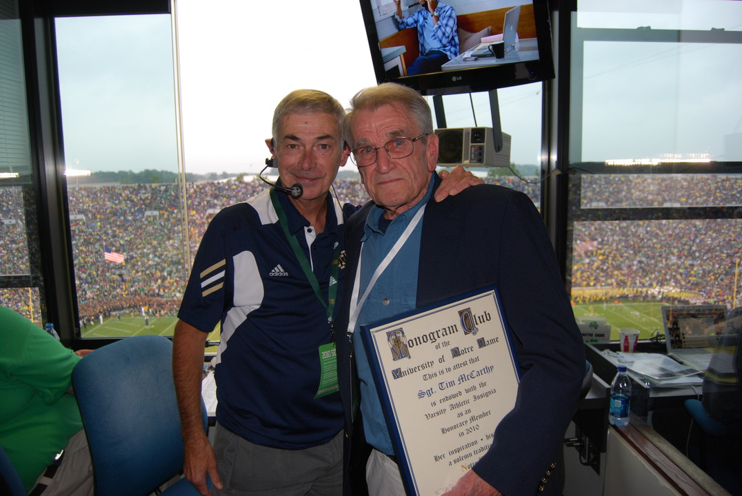 Public address announcer Mike Collins celebrated with McCarthy after he received his Monogram