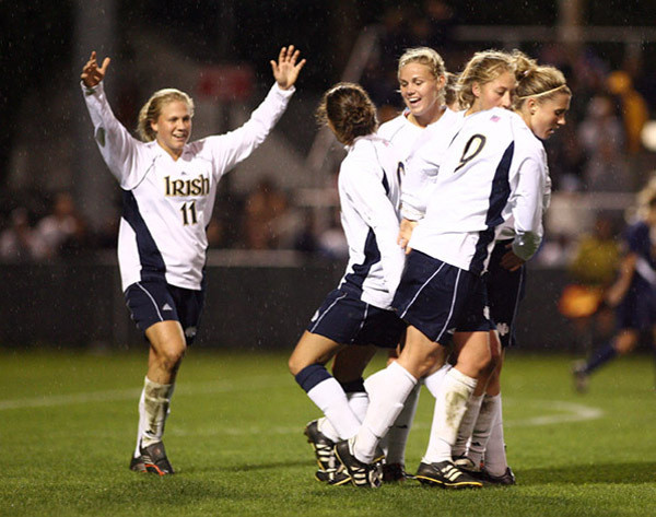 Michele Weissenhofer (left) - the nation's leader in assists and points per game - celebrates the 3-1 win over #6 West Virginia with her teammates (photo by Matt Cashore).
