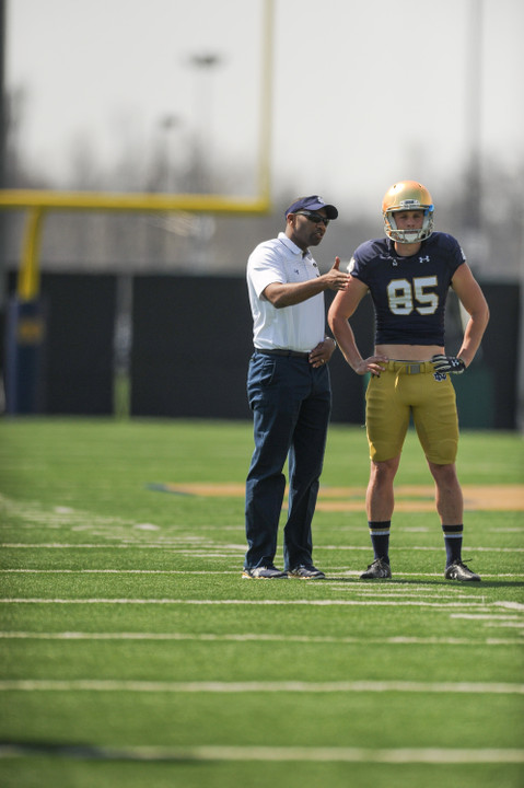 Tyler Newsome receives some instruction from special teams coordinator Scott Booker prior to the spring game.