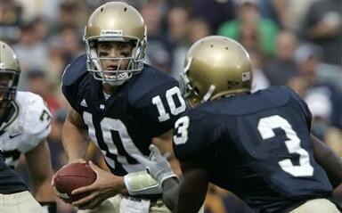Notre Dame quarterback Brady Quinn, left, hands off to running back Darius Walker in the first quarter.  (AP Photo/Michael Conroy)